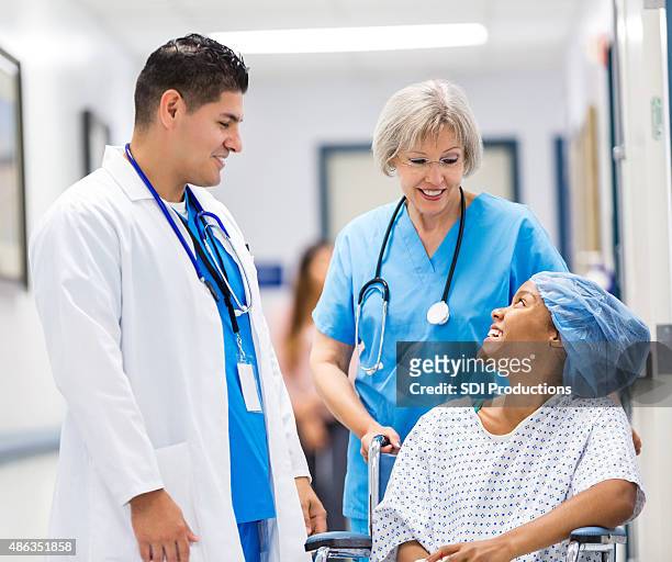 nurse and docgor talking to happy hospital patient after surgery - surgery preparation stock pictures, royalty-free photos & images