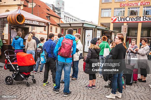 people waiting in line to buy famous trdelnik, prague - trdelník stock pictures, royalty-free photos & images