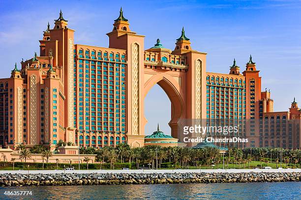 dubai, uae: the iconic atlantis, the palm hotel located on the outer crescent on the man made island, the palm jumeirah - image shot from yacht - atlantis dubai stock pictures, royalty-free photos & images
