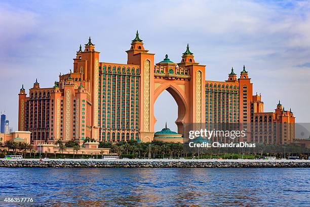 dubai, uae: the iconic atlantis, the palm hotel located on the outer crescent on the man made island, the palm jumeirah - image shot from yacht - atlantis stock pictures, royalty-free photos & images