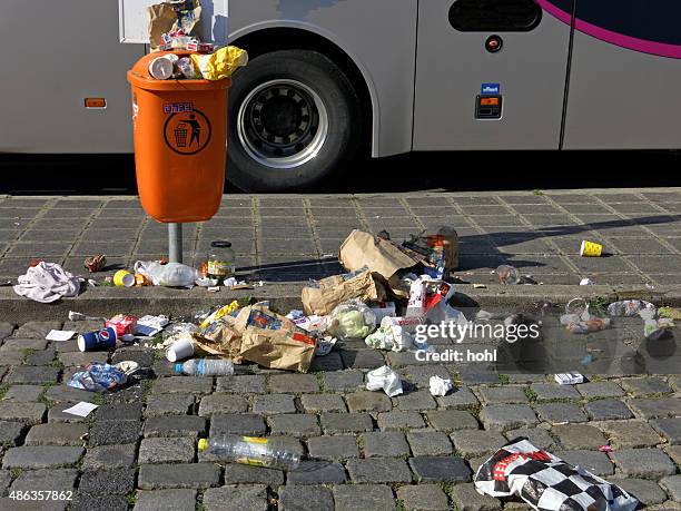 crowded orange garbage can on a bus stop - cup overflow stock pictures, royalty-free photos & images