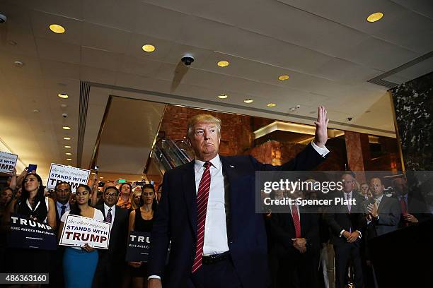 Presidential front-runner Donald Trump exits a news conference in Manhattan after he signed a pledge Thursday to support the Republican nominee in...
