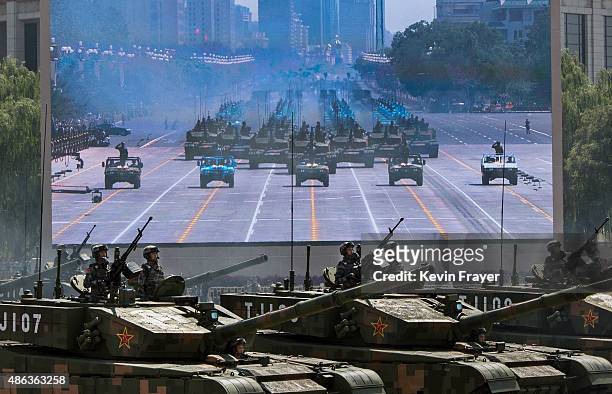 Chinese soldiers ride in tanks as they pass in front of Tiananmen Square and the Forbidden City during a military parade on September 3, 2015 in...