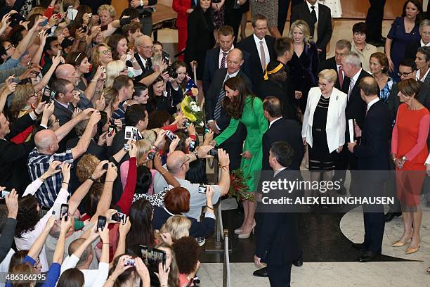 Catherine, the Duchess of Cambridge greets members of the public as her husband Britain's Prince William looks on, upon their departure from a...