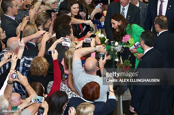 Catherine, the Duchess of Cambridge , accompanied by Australia's Prime Minister Tony Abbott , greets members of the public upon their departure from...