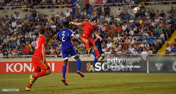 Wales striker Gareth Bale heads the opening goal during the UEFA EURO 2016 Qualifier between Cyprus and Wales at GPS Stadium on September 3, 2015 in...