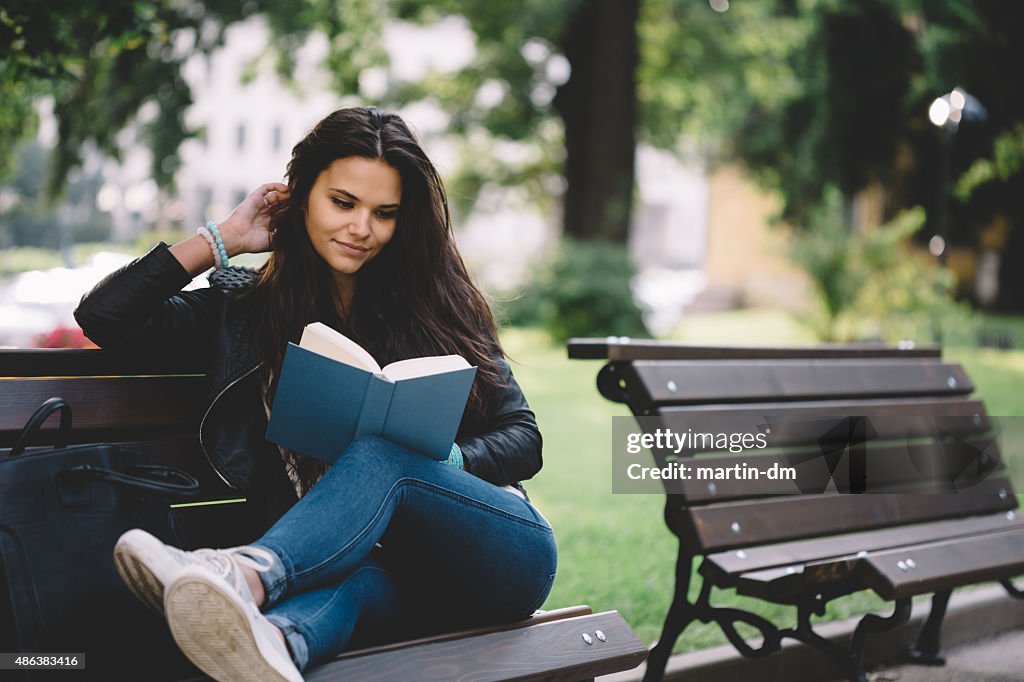 Girl reading a book in the park