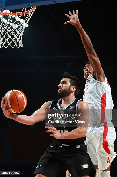 Gabriel Deck of Argentina shoots against Yaser Rodriguez of Cuba during a match between Argentina v Cuba as part of the 2015 FIBA Americas...