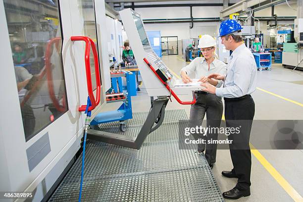 manager and engineer programming a cnc - cnc machine stock pictures, royalty-free photos & images