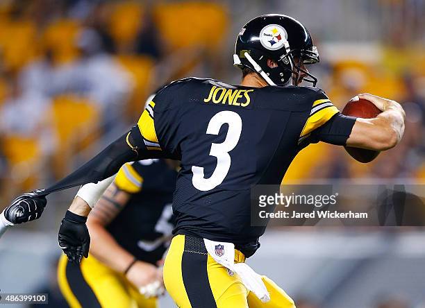 Landry Jones of the Pittsburgh Steelers has his jersey ripped while running with the ball in the first half against the Carolina Panthers during the...
