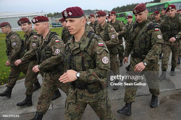 Members of a Polish paratrooper unit march to assemble prior to the arrival of soldiers of the U.S. Army 173rd Airborne Brigade at a Polish air force...