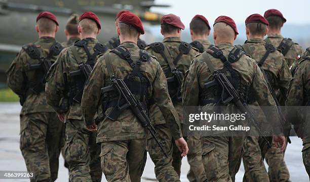 Members of a Polish paratrooper unit march to assemble prior to the arrival of soldiers of the U.S. Army 173rd Airborne Brigade at a Polish air force...