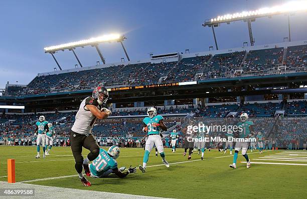 Adam Humphries of the Tampa Bay Buccaneers scores a touchdown during a preseason game against the Miami Dolphins at Sun Life Stadium on September 3,...