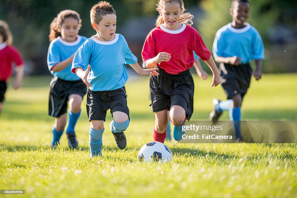 Children Rush to Soccer Ball
