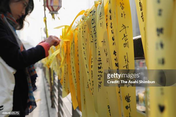 Family members of the missing passengers of sunken ferry 'Sewol' writes a message onto yellow ribbons on April 24, 2014 in Seoul, South Korea. The...