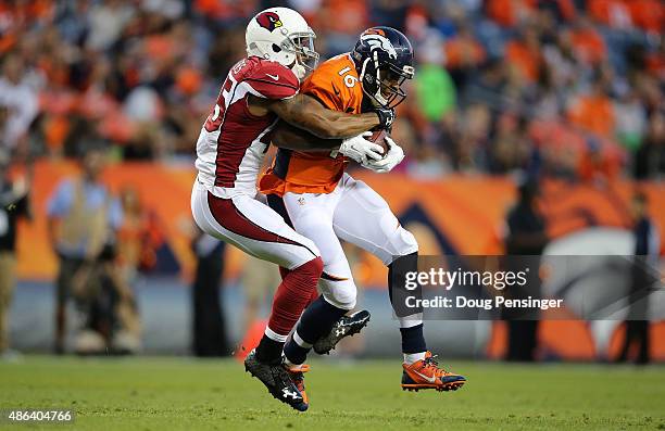 Bennie Fowler of the Denver Broncos makes a pass reception as Anthony Walters of the Arizona Cardinals makes the tackle during preseason action at...