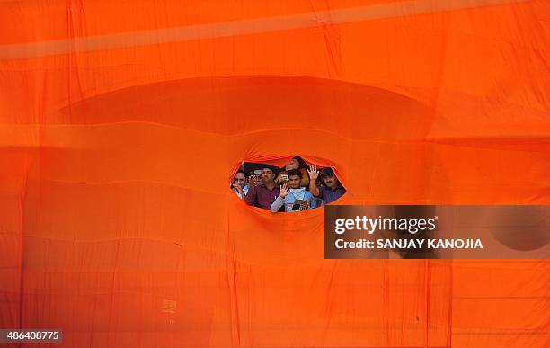 Supporters of unseen India's main opposition Bharatiya Janata Party prime ministerial candidate and Chief Minister of the western Indian state of...