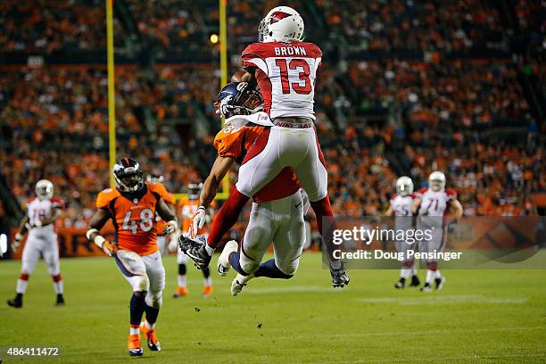 Cornerback Curtis Marsh of the Denver Broncos is penalized for pass interference as he defends against Jaron Brown of the Arizona Cardinals during...