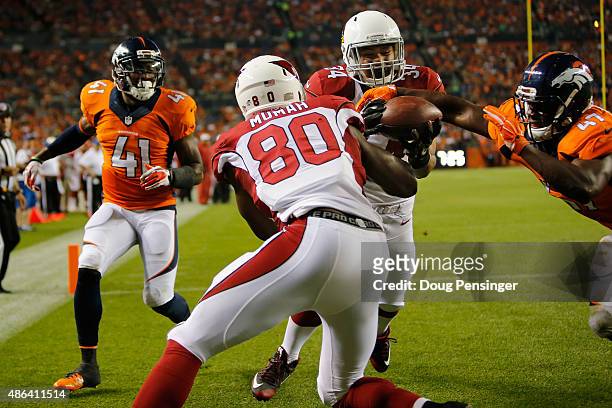 Paul Lasike of the Arizona Cardinals comes up with the ball for a touchdown reception between teammate Ifeanyi Momah of the Arizona Cardinals and...