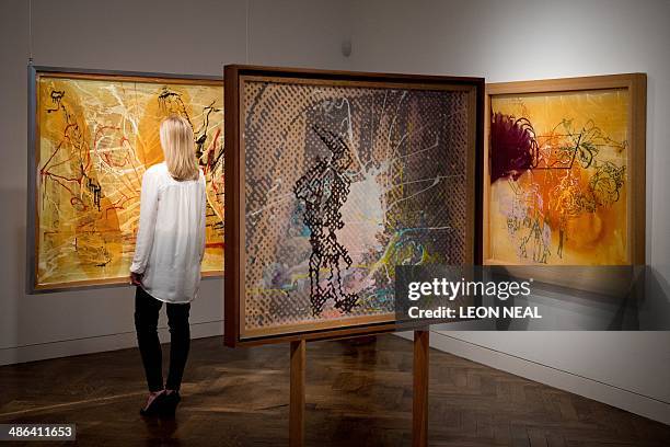 Christie's employee poses for photographs during a preview of an exhibition featuring the works of German Artists Gerhard Richter and Sigmar Polke,...