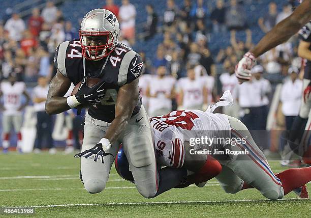 Asante Cleveland of the New England Patriots is stopped Ashlee Palmer of the New York Giants during a pre-season game the New England Patriots in the...