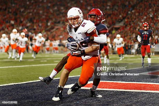Tight end David Morgan II of the UTSA Roadrunners catches a six yard touchdown reception past cornerback Devin Holiday of the Arizona Wildcats during...