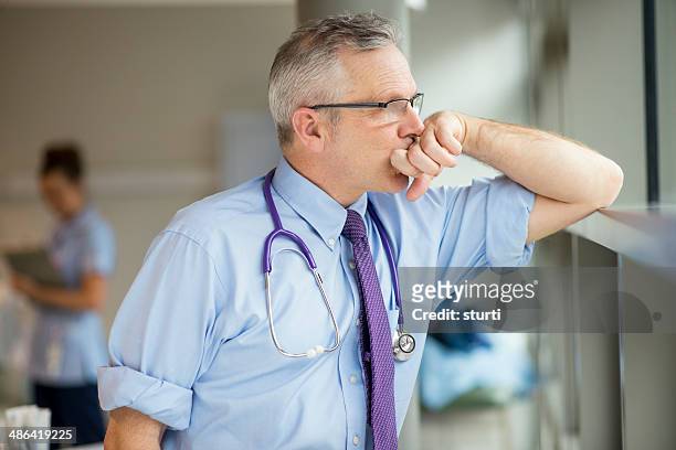 exhausted doctor - worried doctor stock pictures, royalty-free photos & images