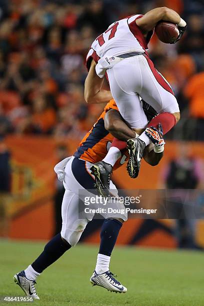 Kapri Bibbs of the Denver Broncos makes a tackle on Trevor Harman of the Arizona Cardinals on a punt return during preseason action at Sports...