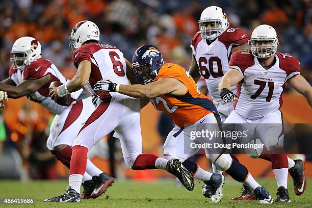 Sione Fua of the Denver Broncos sacks quarterback Logan Thomas of the Arizona Cardinals during preseason action at Sports Authority Field at Mile...