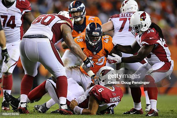 Shaquil Barrett of the Denver Broncos sacks quarterback Logan Thomas of the Arizona Cardinals during preseason action at Sports Authority Field at...