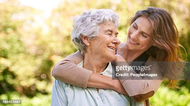 my mom means the world to me - young woman and senior lady in a park stock pictures, royalty-free photos & images