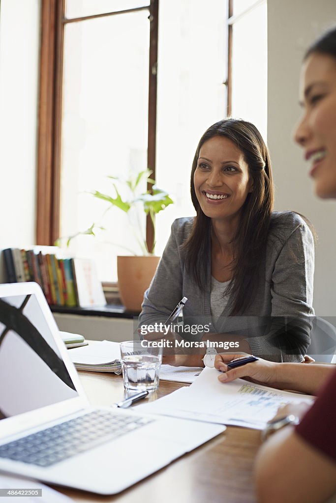 Portrait of smiling business woman during meeting