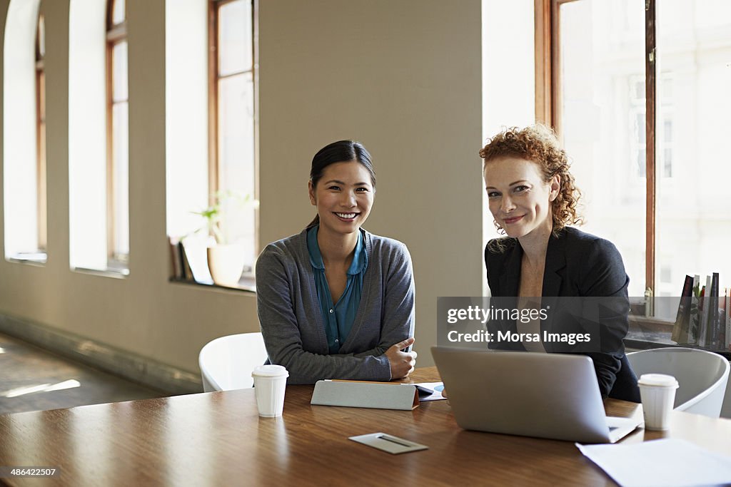 Portrait of business women at table