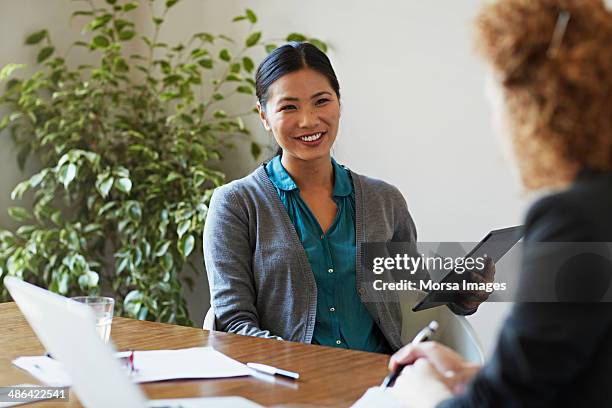 business women discussing project - asian women positive emotion stock pictures, royalty-free photos & images