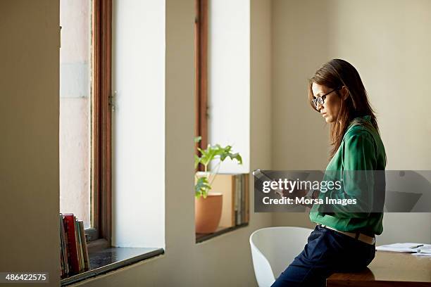 business woman using digital tablet - ledge stock pictures, royalty-free photos & images