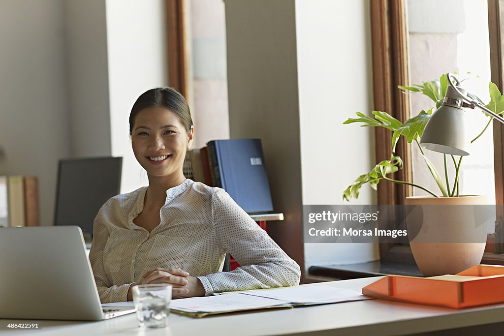 Portrait of business woman at work station