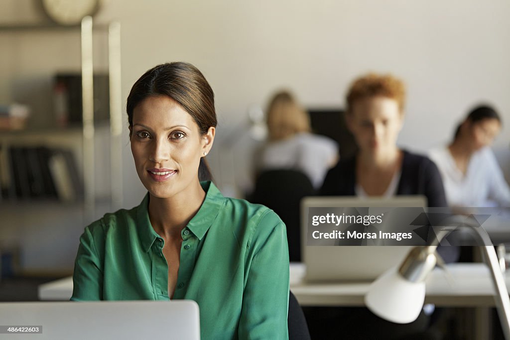 Portrait of business woman at work station