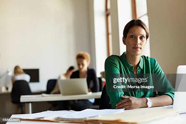 portrait of business woman at work station - incidental people stock pictures, royalty-free photos & images