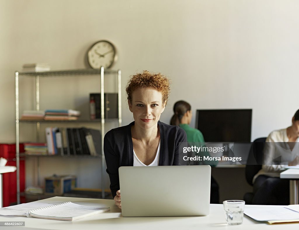Portrait of business woman at work station