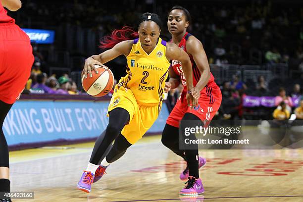 Tameka Johnson of the Los Angeles Sparks drives to the basket against Ivory Latta of the Washington Mystics in a WNBA game at Staples Center on...