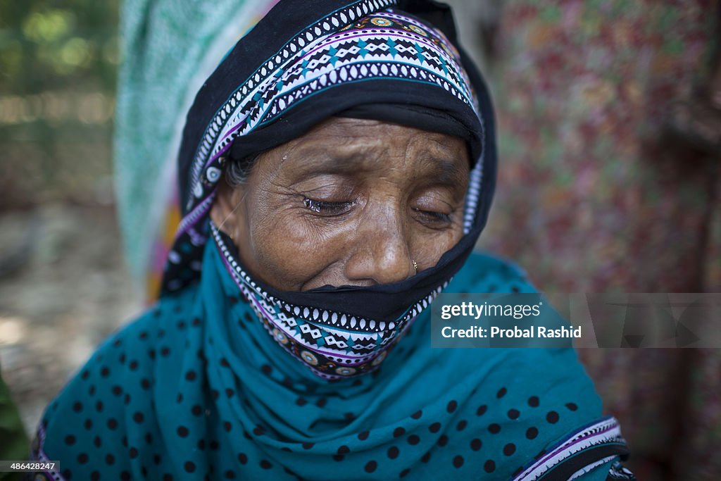 Relatives of the dead and missing workers mourn as they...