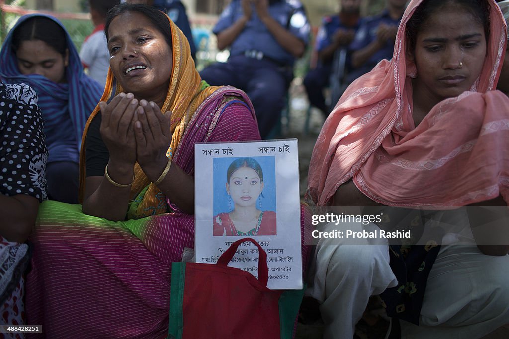 Relatives of the dead and missing workers mourn as they...