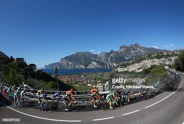 The peloton stretches out from the village of Nago above Lake Garda during stage three of the Giro del Trentino from Mori to Roncone on April 24,...