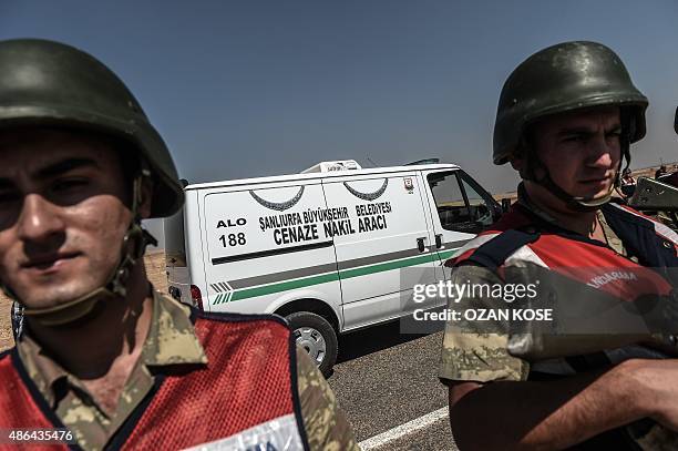 The hearse carrying the body of three-year old Aylan Kurdi, runs by Turkish soldiers on its way to Kobane , on September 4, 2015 near the...