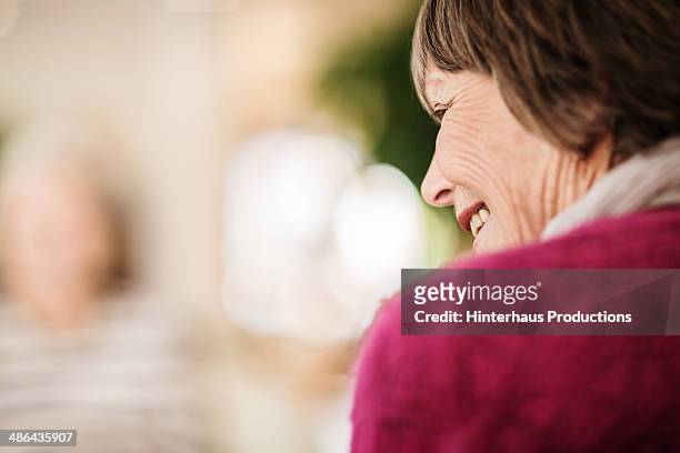 rear view of senior woman - selective focus stock-fotos und bilder