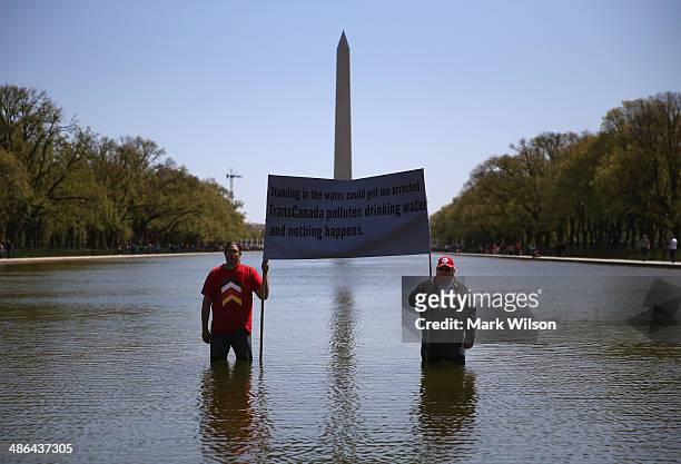 Keystone pipeline protesters Wizipan Little Elk of the Rosebud Sioux Tribe and Nebraska farmer Art Tanderup hold a sign protesting the pipeline while...