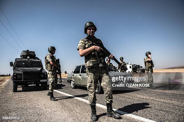 Turkish soldiers stand guar near the Turkey-Syrian border post in Sanliurfa, on September 4 as they wait for the arrival of the hearse carrying the...