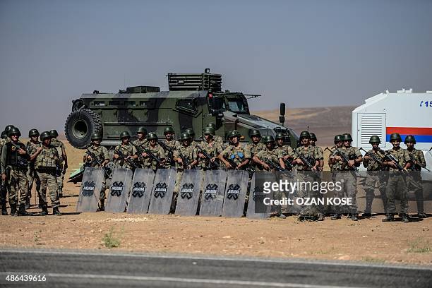 Turkish soldiers stand guar near the Turkey-Syrian border post in Sanliurfa, on September 4 following the crossing of the hearse carrying the body of...