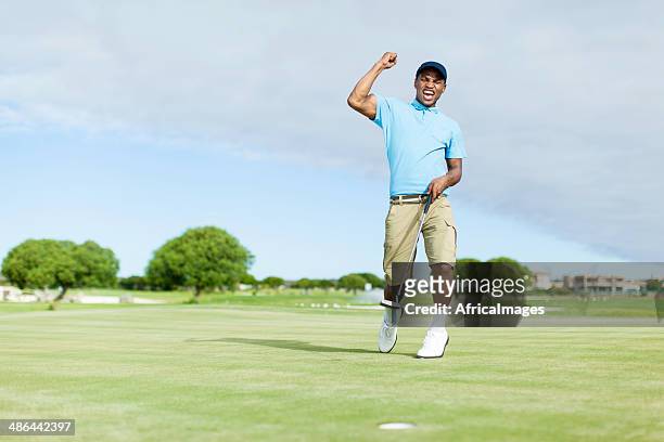 african golfer celebrating his win! - male golfer stock pictures, royalty-free photos & images