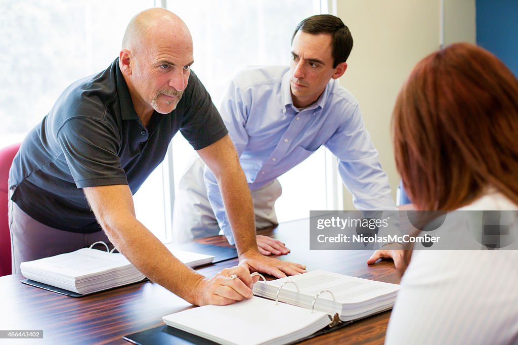 Office worker aggressively makes a point during meeting